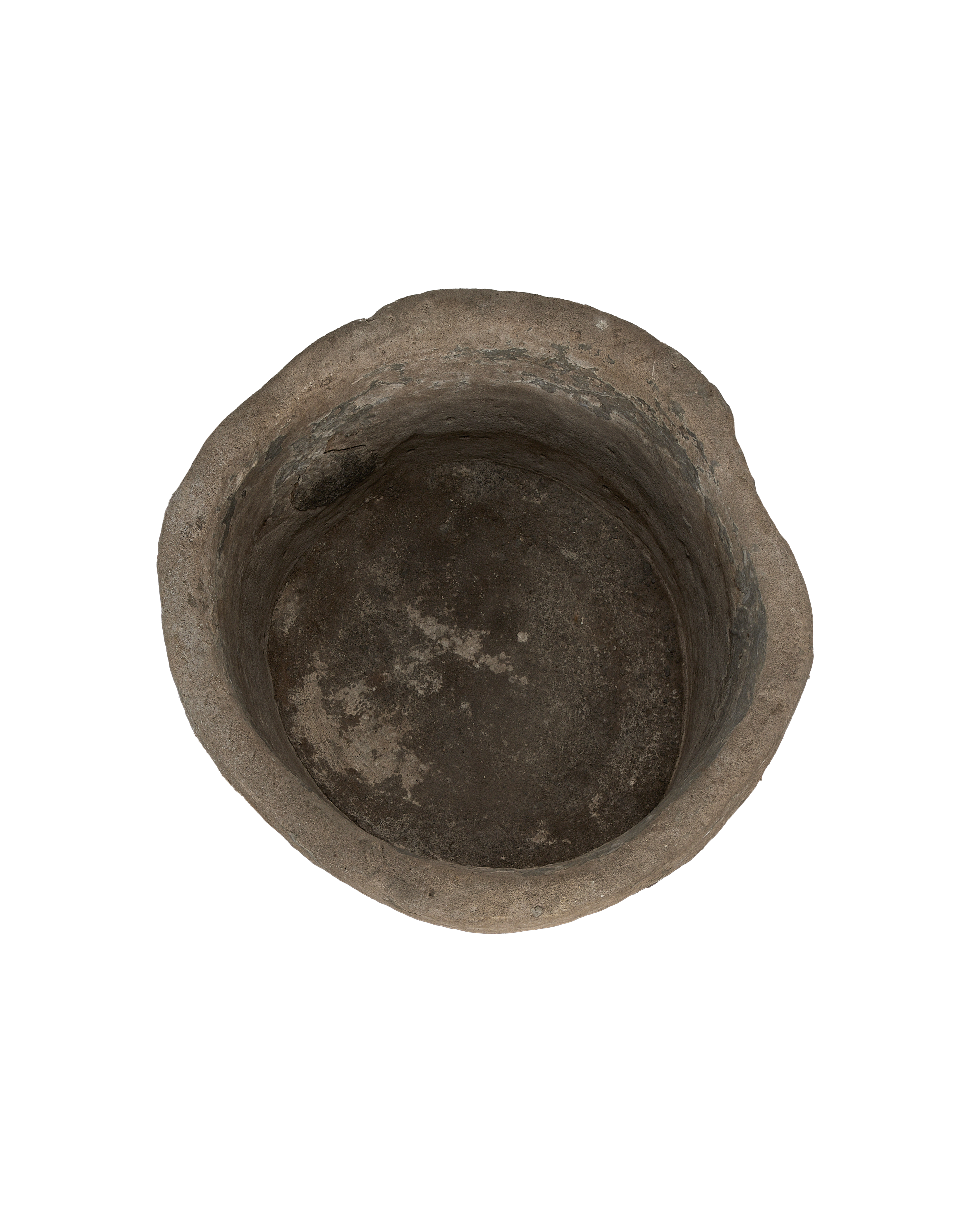 Vintage round Indonesian limestone trough, top-down view showing weathered interior texture.