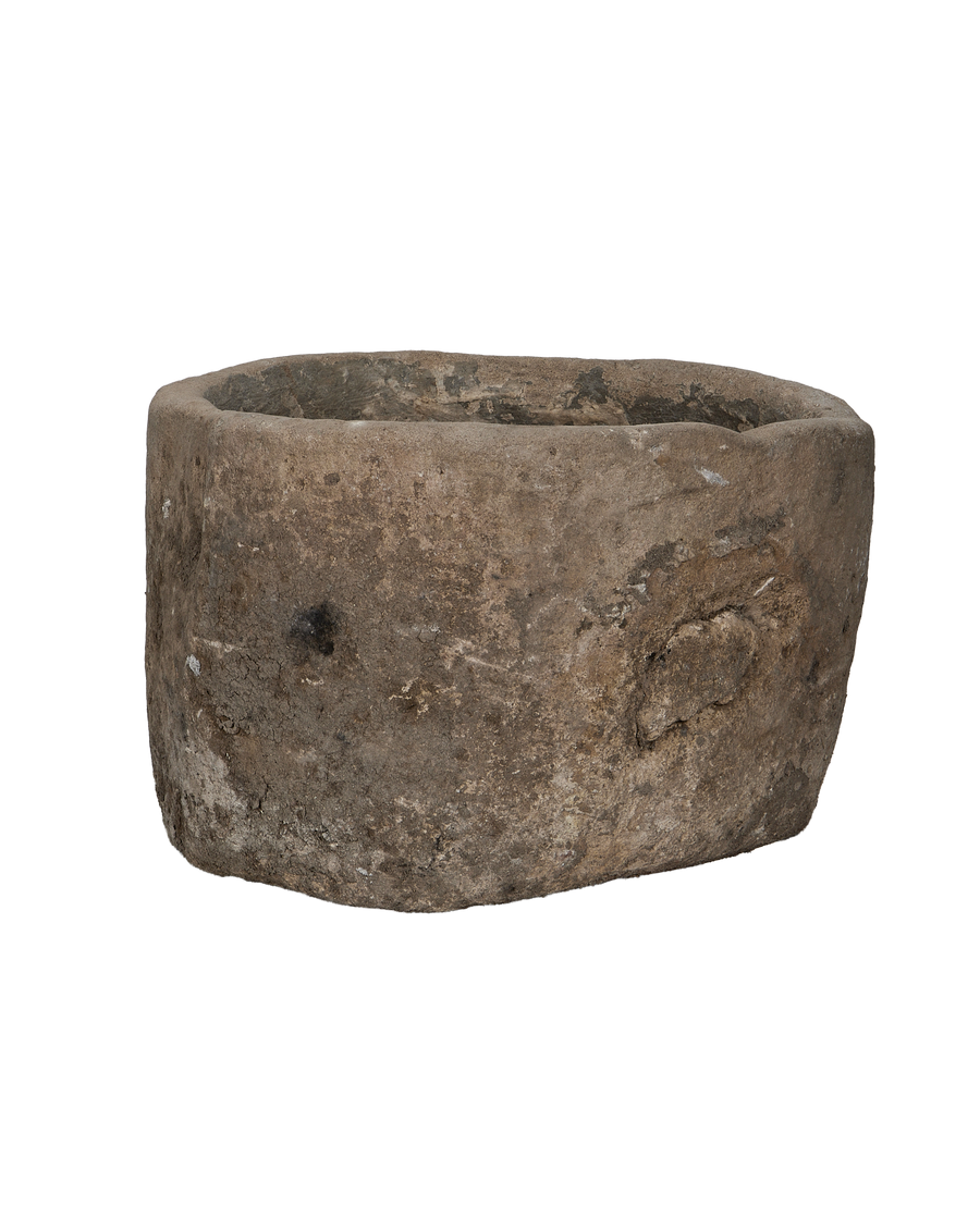 Vintage Indonesian limestone trough, showing unique aged texture and rounded interior.