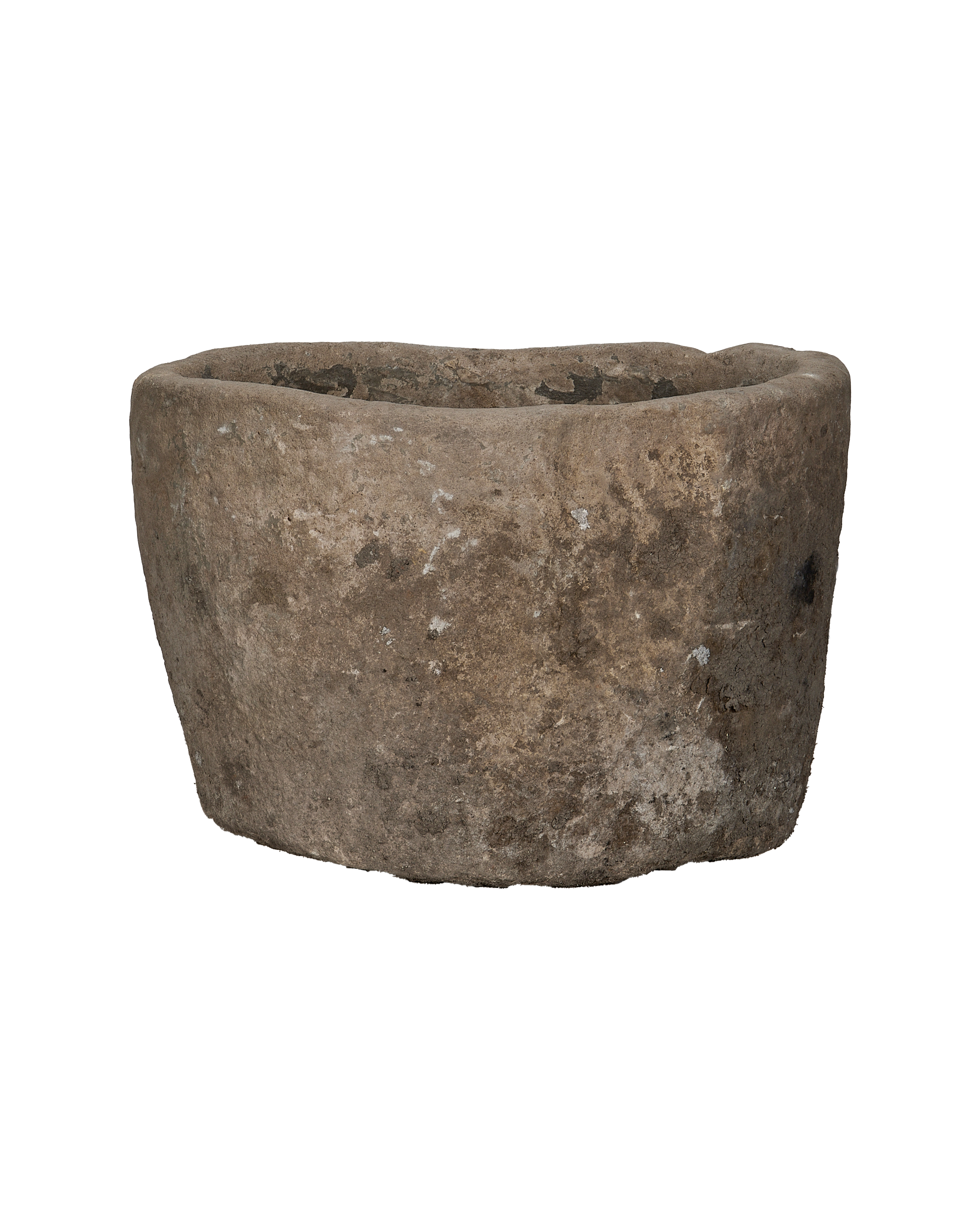 Vintage Indonesian limestone trough, round, showing detailed weathered surface texture, side view.
