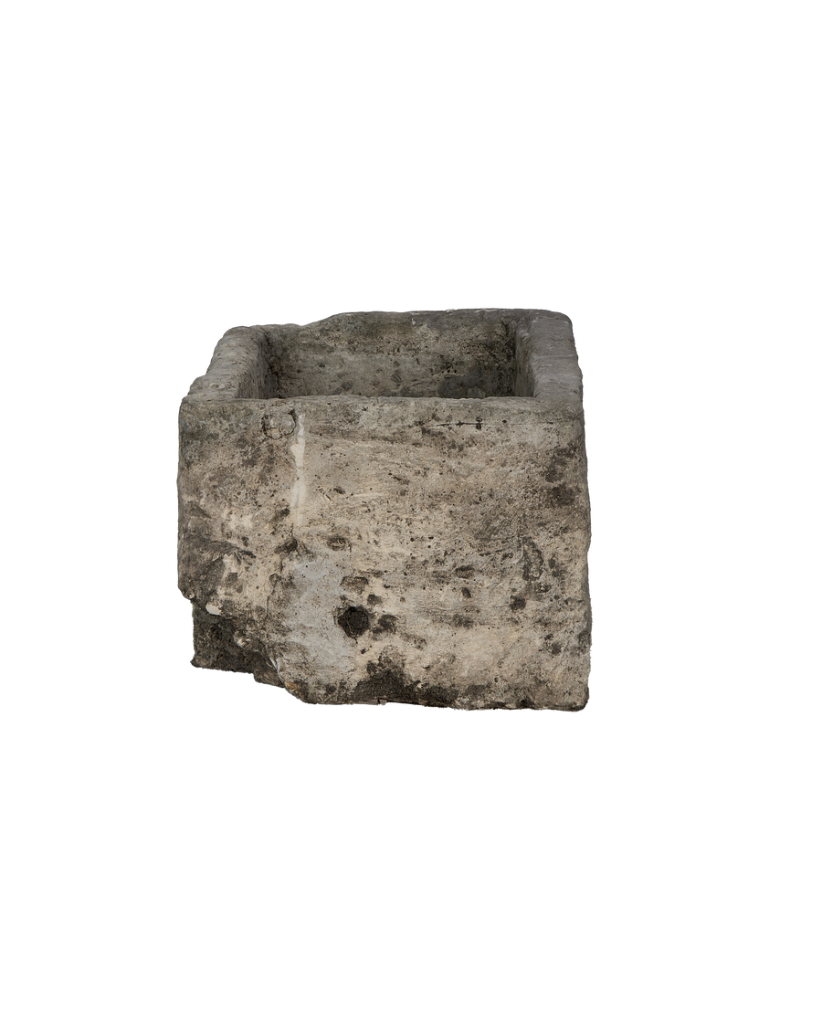 Vintage Indonesian limestone trough showing weathered, textured surface and worn edges.