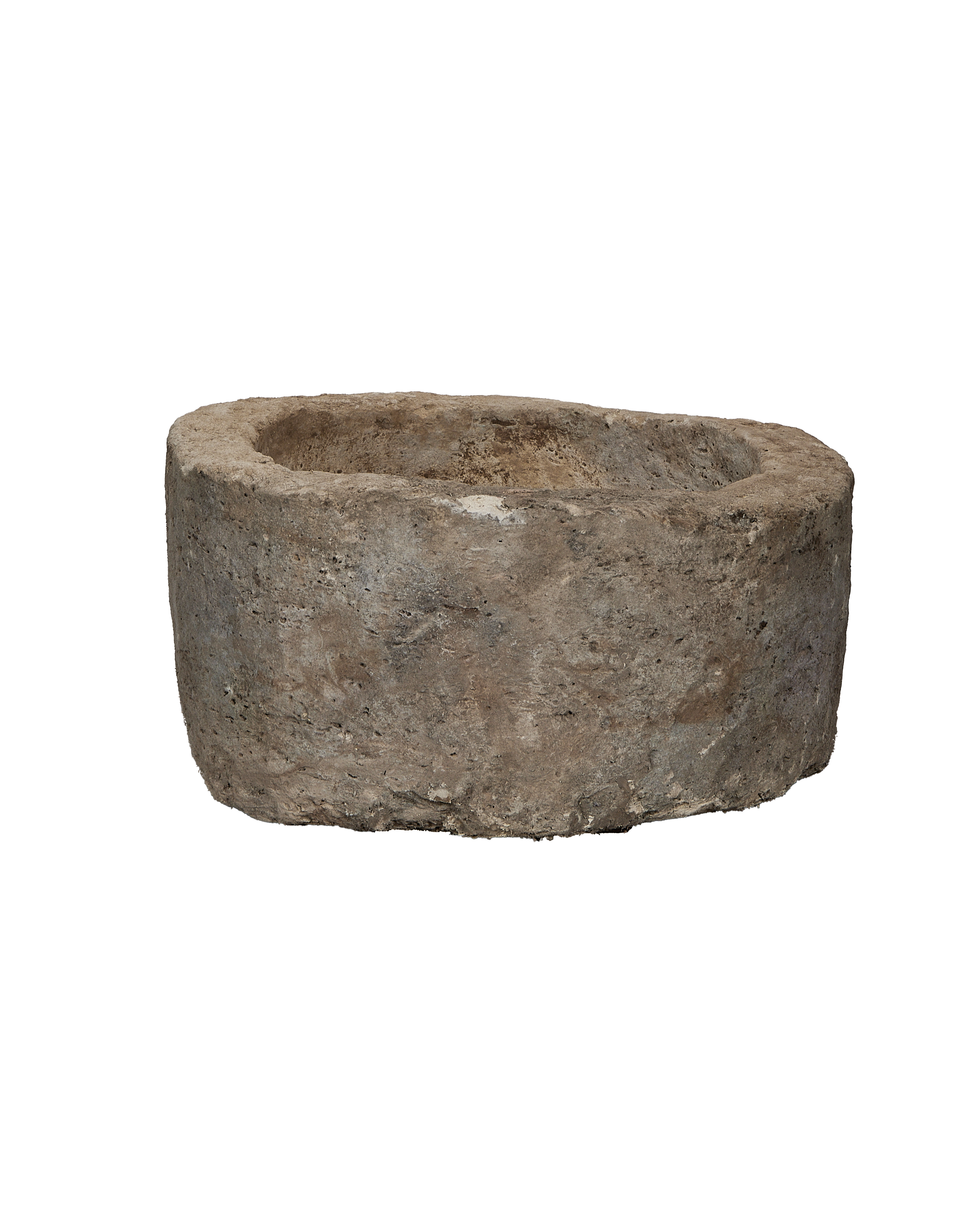 Vintage Indonesian limestone trough, round, showing weathered, rough texture from a side angle.