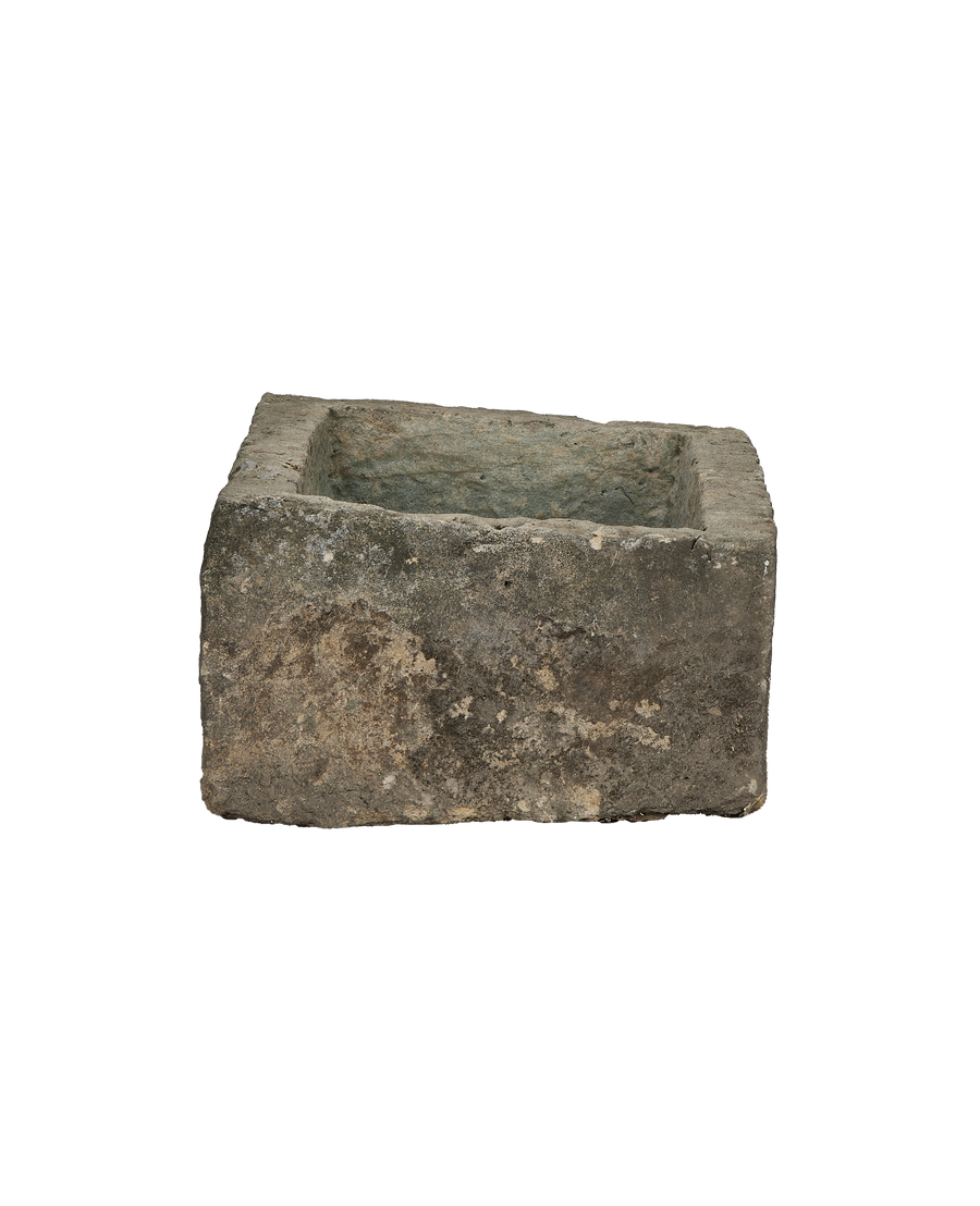 Vintage Indonesian limestone trough, top-down view showing weathered rectangular basin with rough texture.