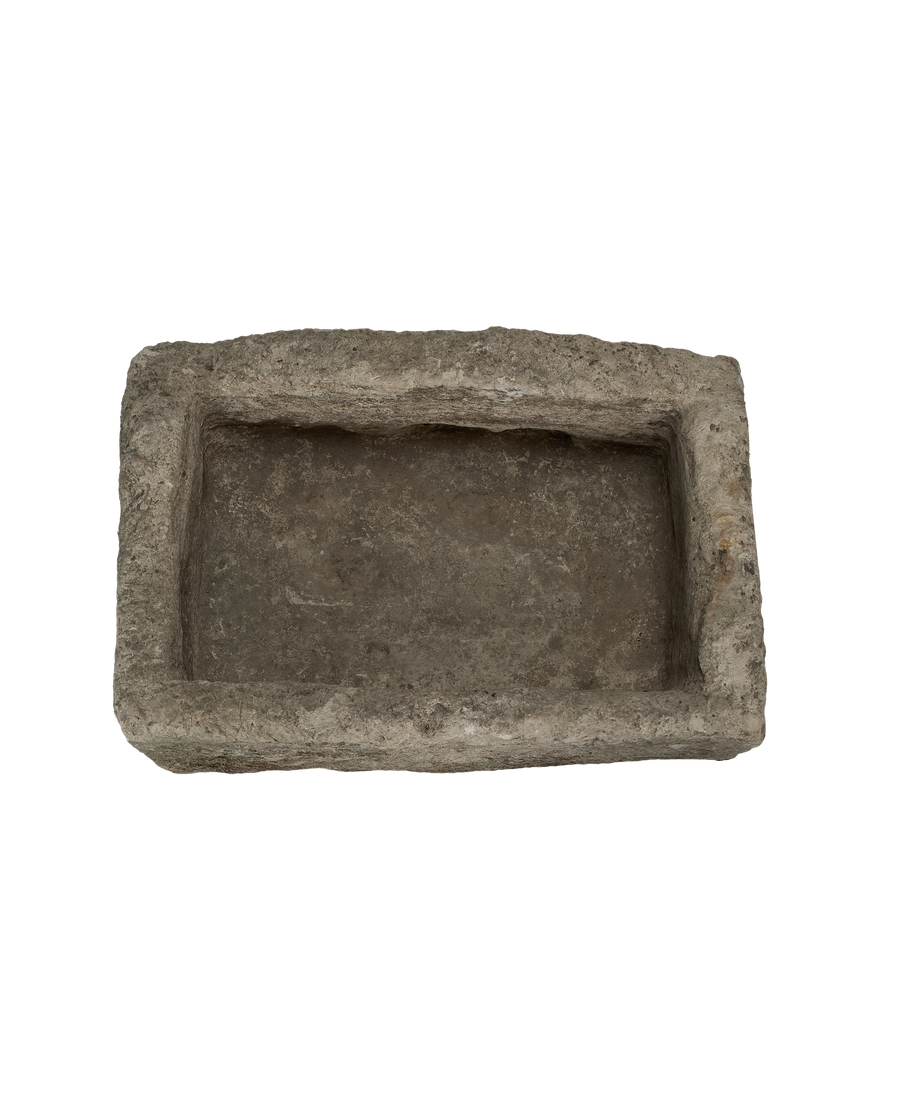 Vintage rectangular limestone trough, showing the rough, weathered interior surface from above.