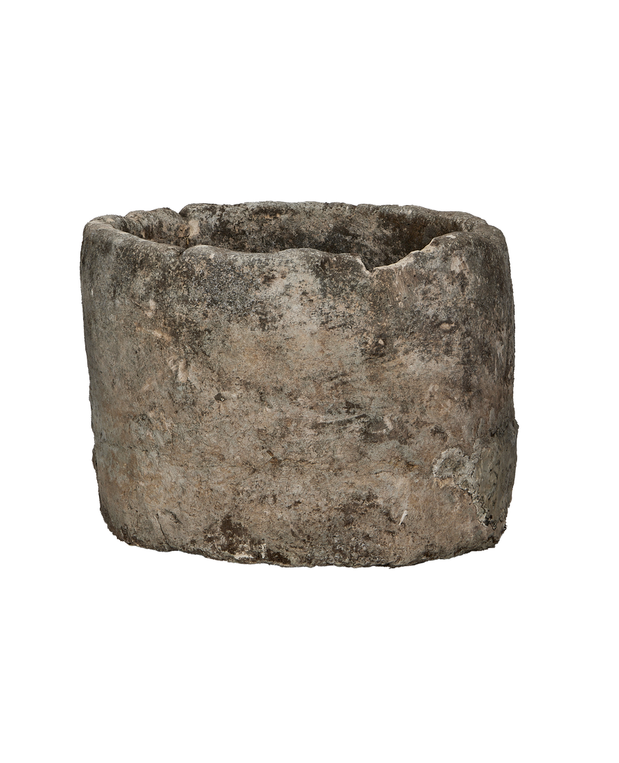 Vintage round Indonesian limestone trough, showing distressed texture and aged patina.