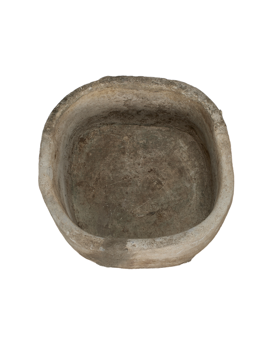 Vintage round limestone trough, top-down view showing weathered patina and rustic interior.