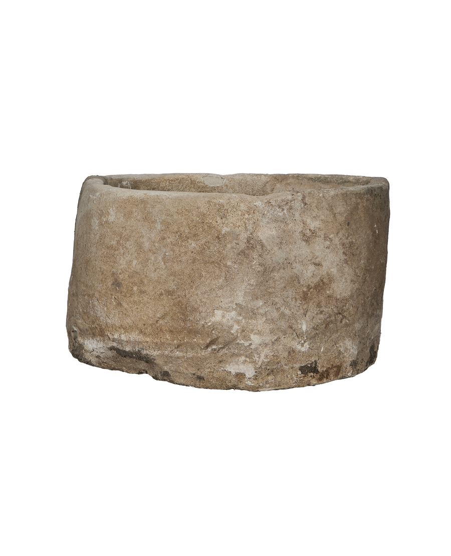 Vintage Indonesian round limestone trough, full-side view exposing distressed aged oak-like texture.
