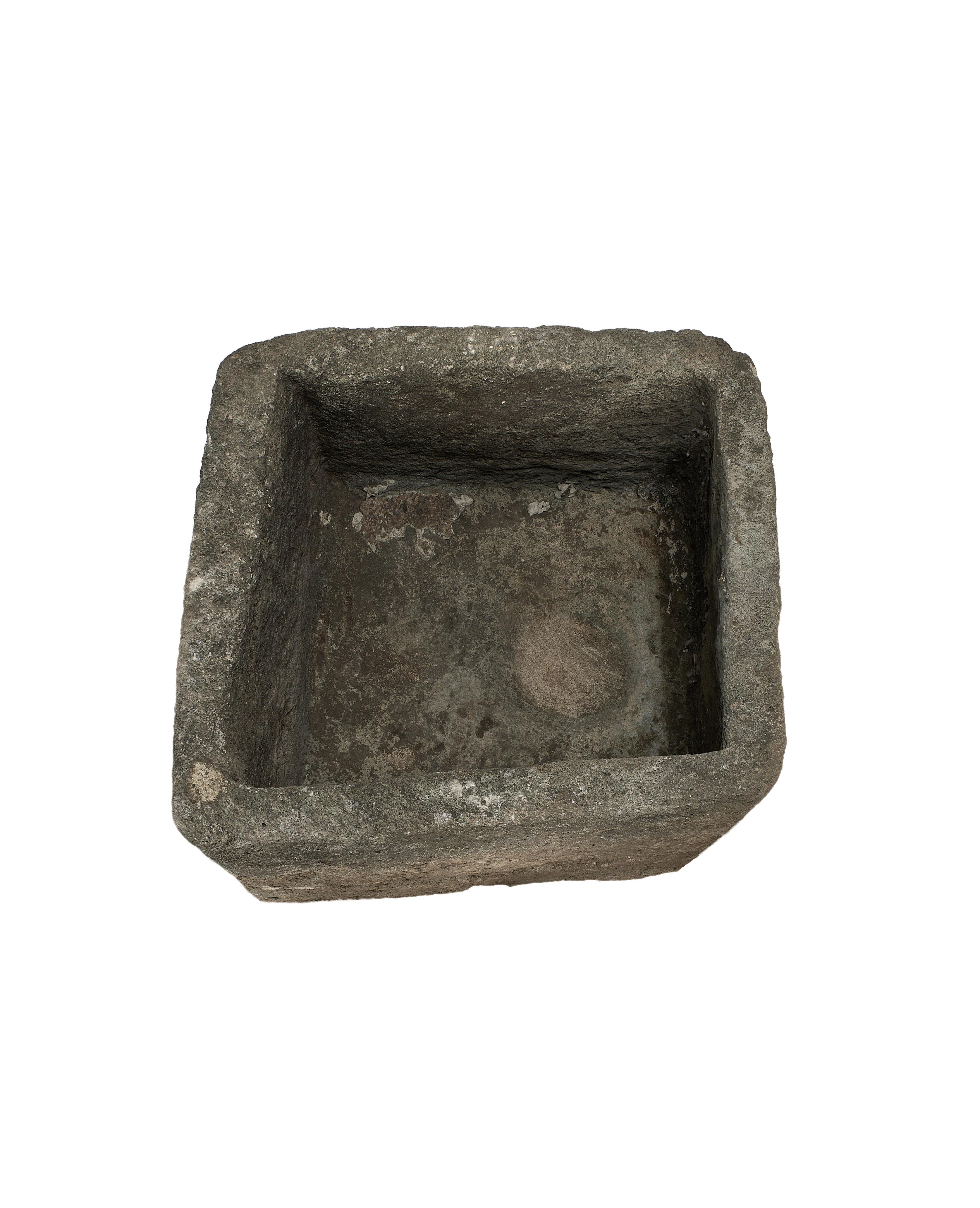 Vintage square limestone trough, top view showcasing weathered interior and rough stone edges.
