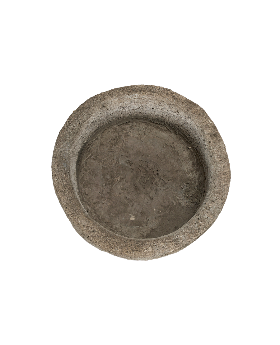 Vintage Indonesian round limestone trough, top-down view showing weathered interior texture.