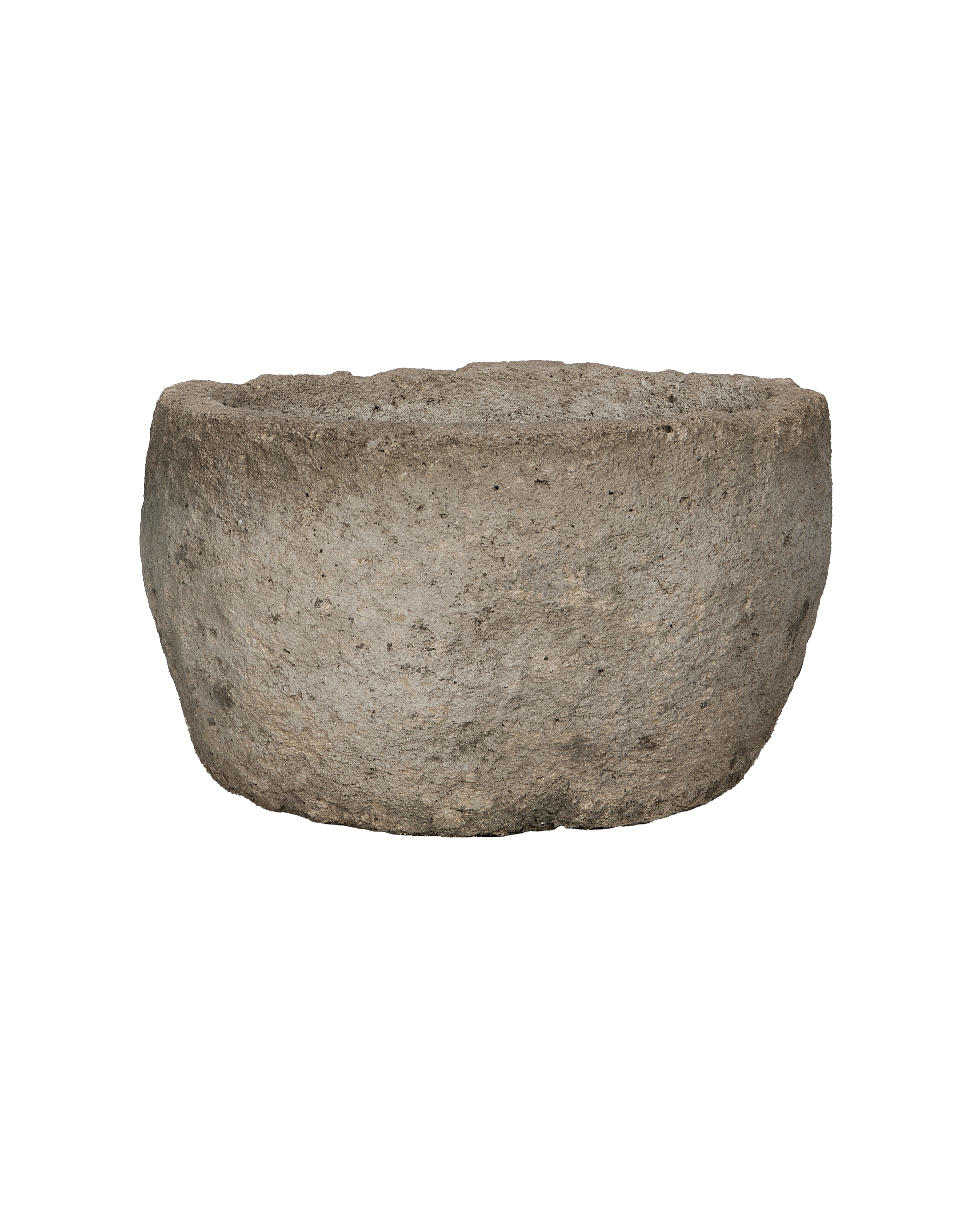 Vintage round Indonesian limestone trough, showing rough textured exterior and natural stone finish.