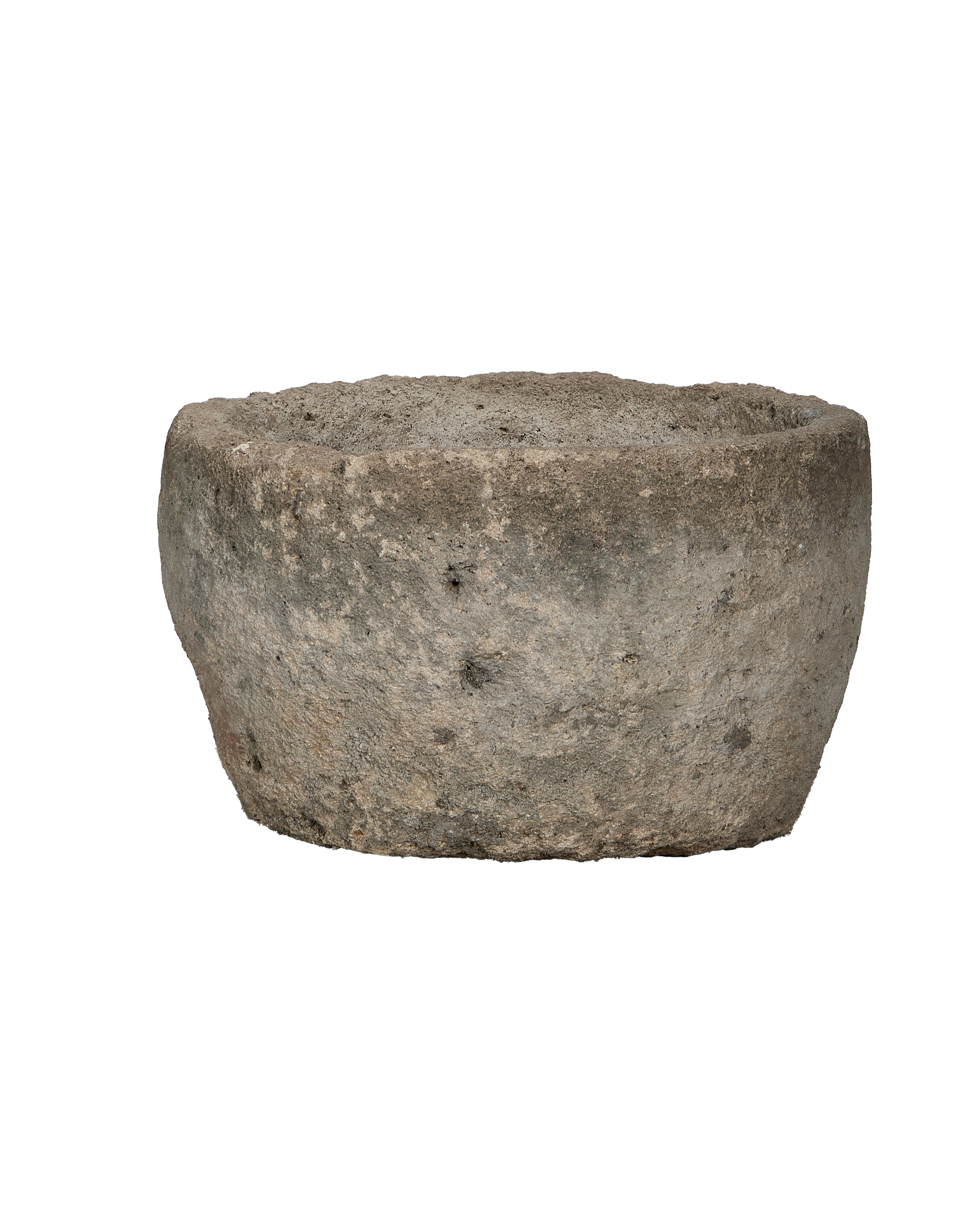 Vintage Indonesian round limestone trough, showing its aged, weathered surface and organic texture from a lower side angle.