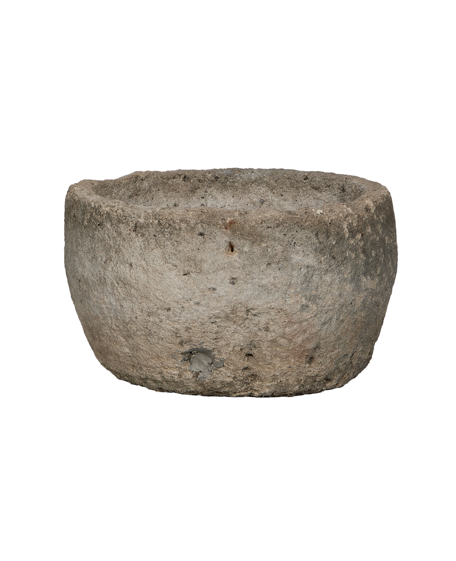 Vintage Indonesian round limestone trough, rich textured surface, showing age and character.