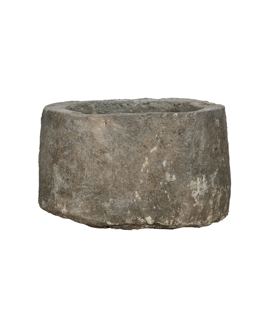 Vintage Indonesian round limestone trough, showing weathered texture and aged patina.