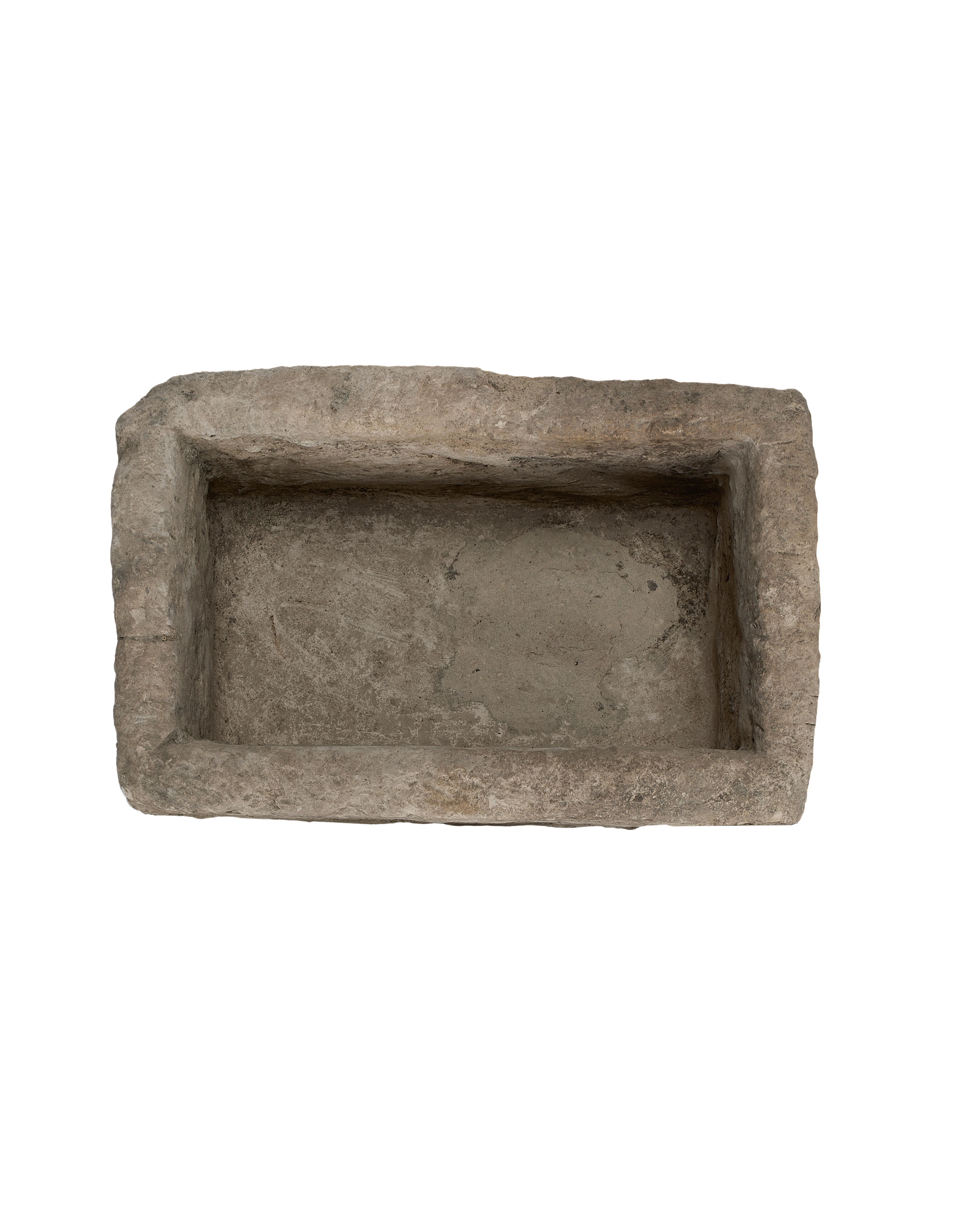 Vintage Indonesian limestone trough viewed top-down, highlighting weathered interior and irregular edges.