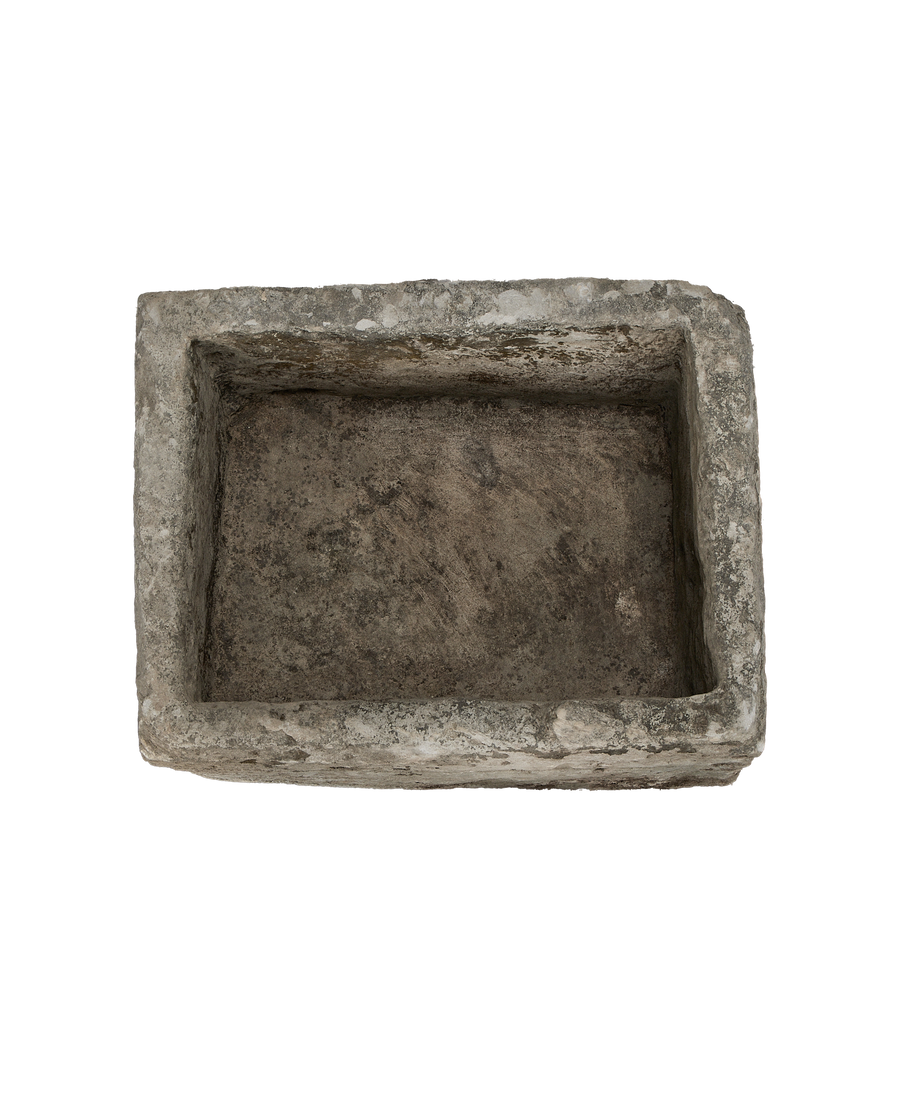 Overhead view of vintage rectangular Indonesian limestone trough with rough, weathered interior.