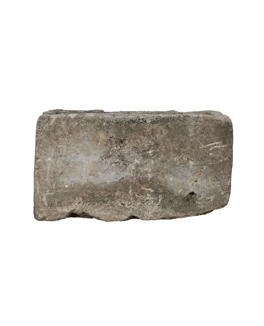Vintage rectangular limestone trough, showing a side angle with natural pitting and weathered texture.