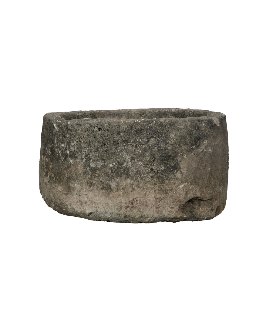 Vintage Indonesian round limestone trough, showing weathered texture and natural imperfections.