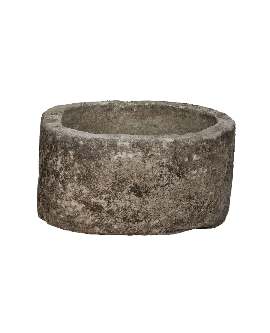 Vintage round limestone trough, side profile, revealing exterior texture and inner depth.