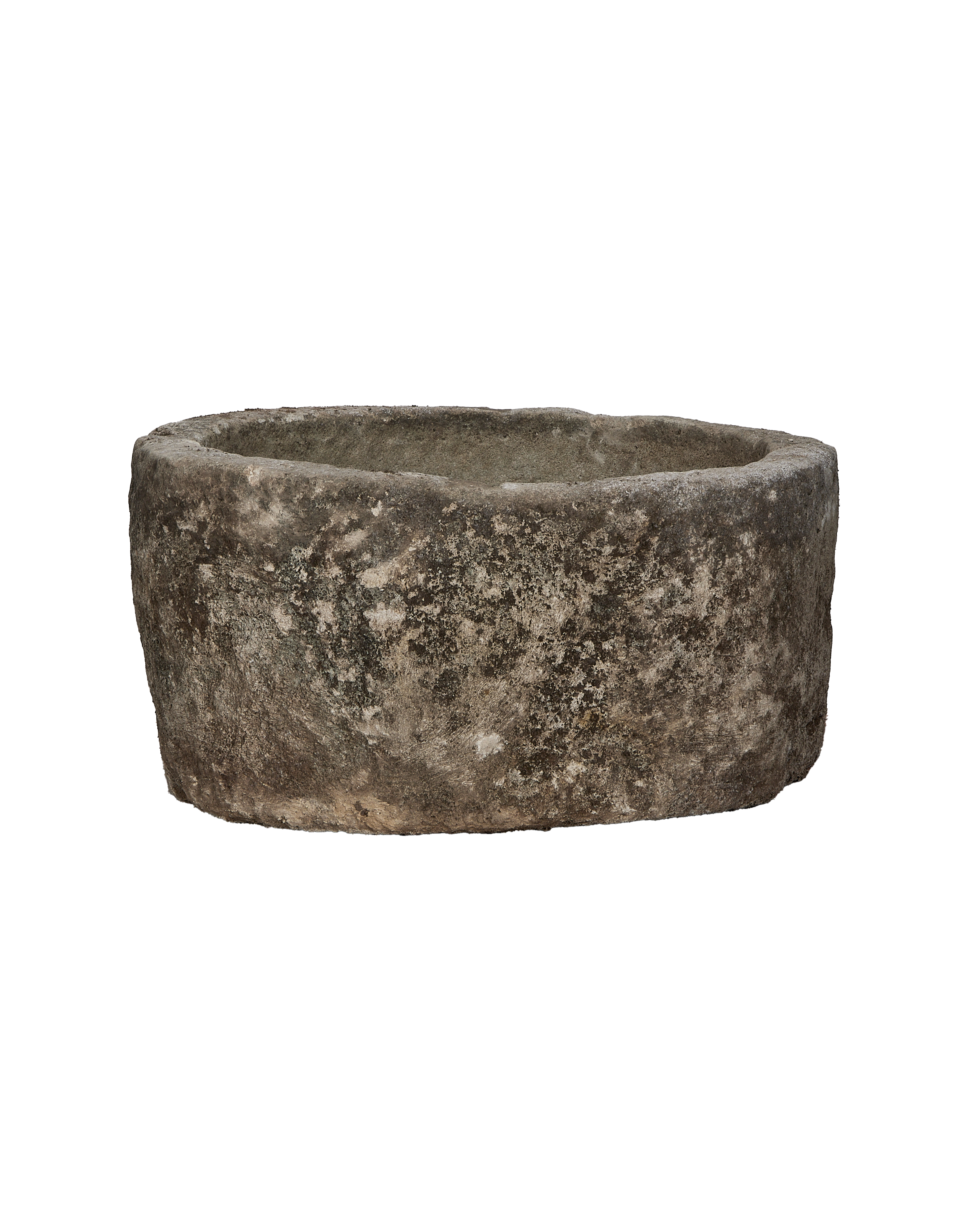 Vintage Indonesian limestone trough, round, showing weathered texture and natural imperfections, slightly angled view.