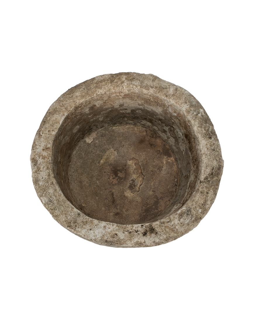 Vintage Indonesian round limestone trough, top-down view showing interior texture and depth.
