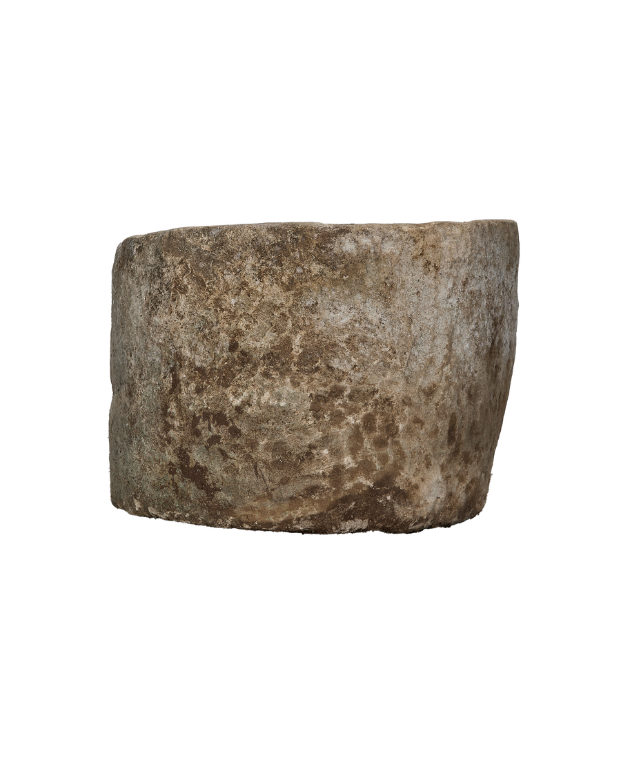 Vintage Indonesian limestone trough, round, showing detailed side texture and natural weathered patina.