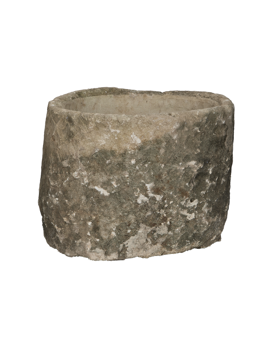 Vintage Indonesian round limestone trough, showing weathered texture from a unique low angle.