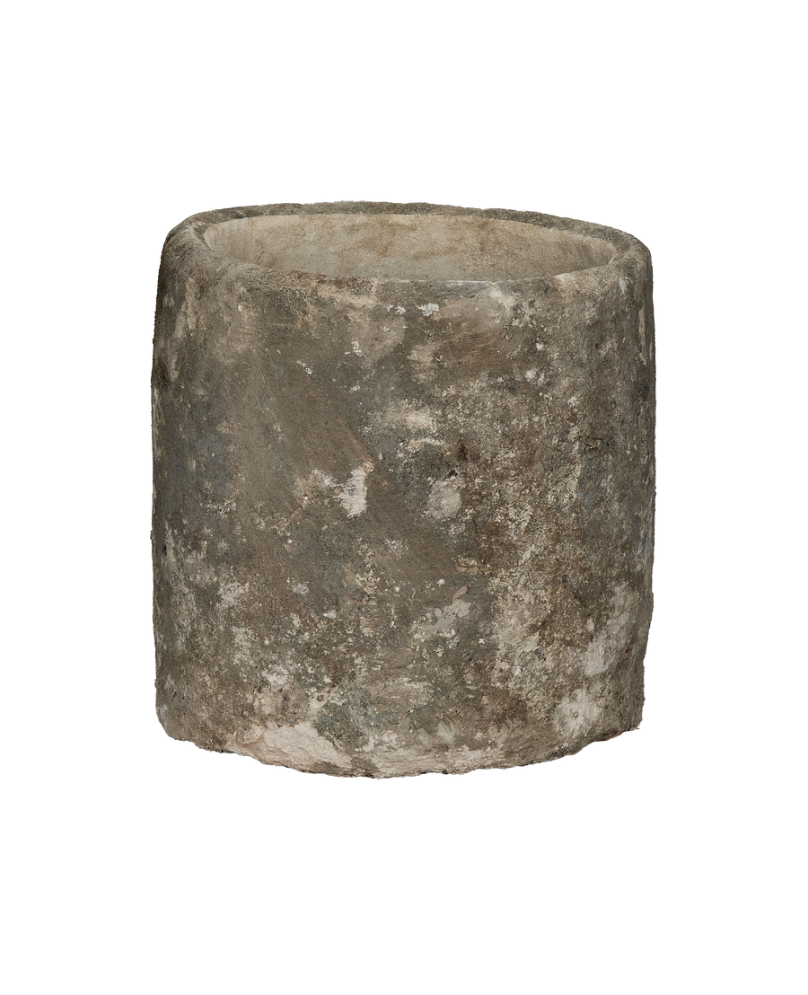 Vintage Indonesian limestone trough, round, showing detailed weathered surface texture, side view.