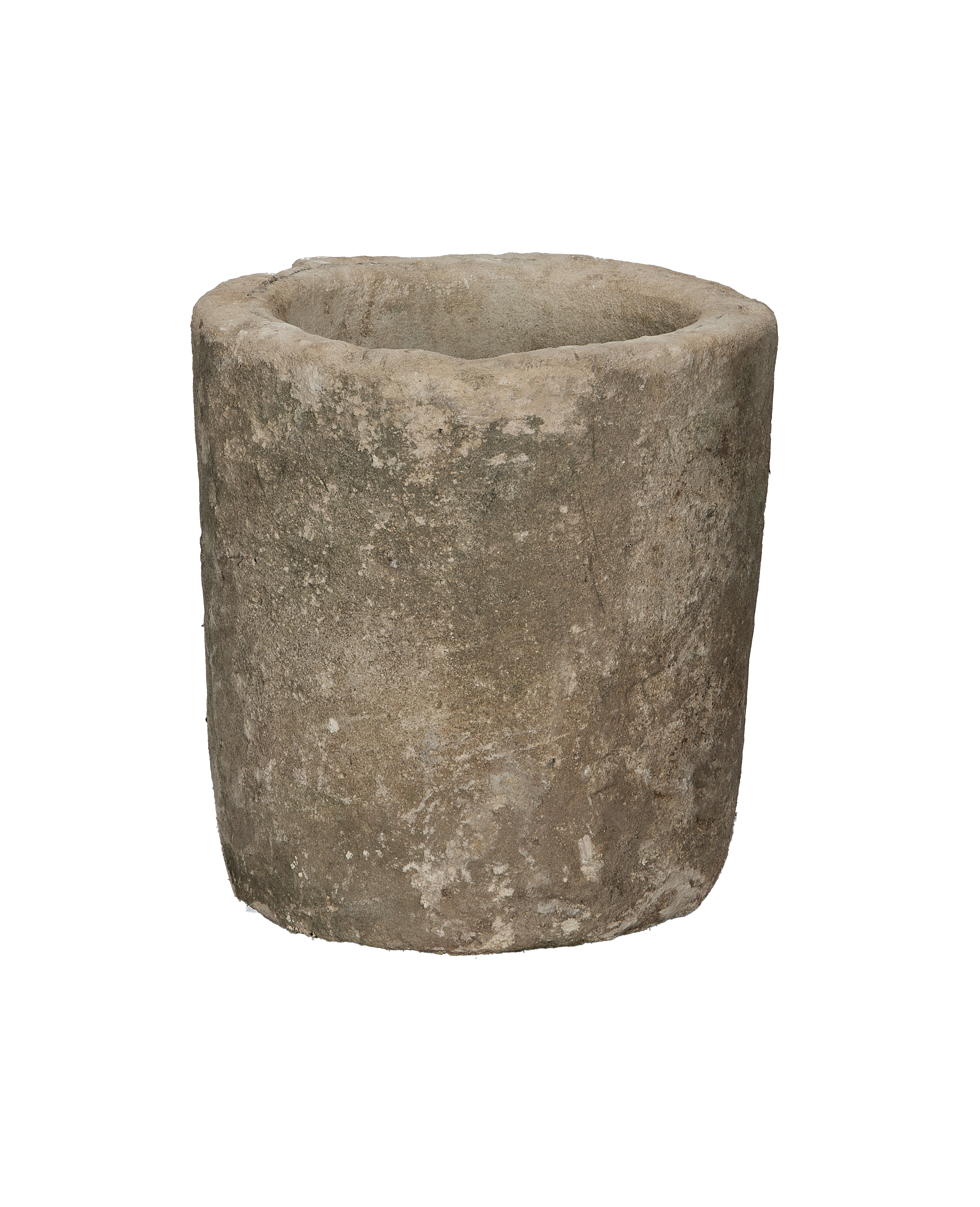 Vintage round Indonesian limestone trough showing weathered, textured exterior from a side angle.