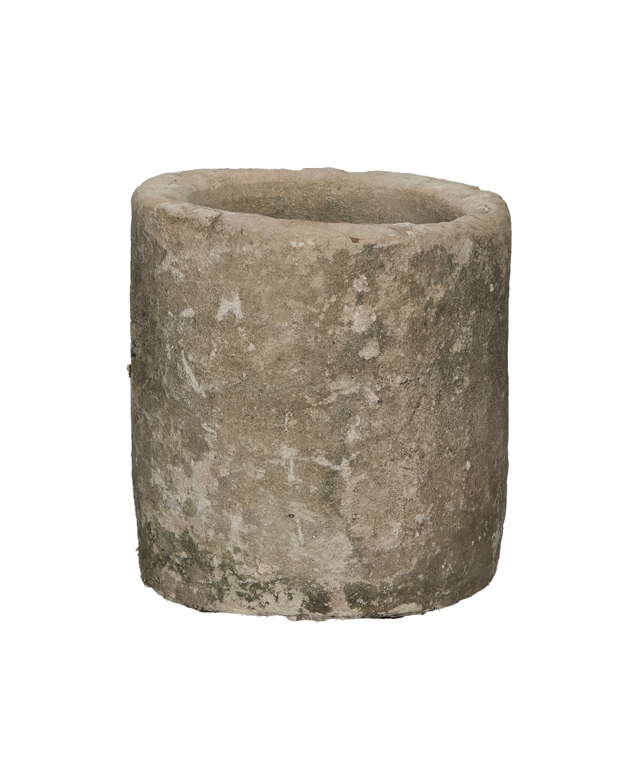 Round vintage Indonesian limestone trough, top-down view showing textured surface with moss.