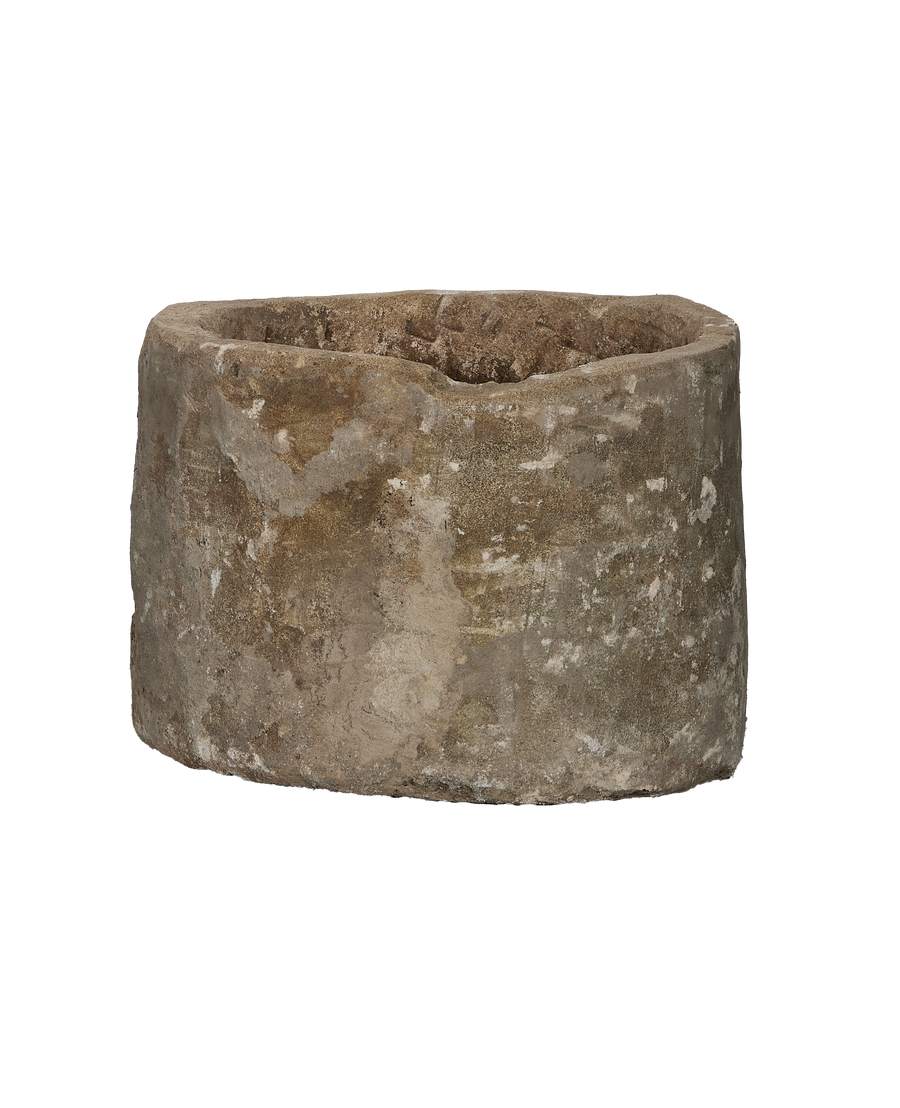 Vintage Indonesian round limestone trough, showing weathered side texture and rough rim detail.
