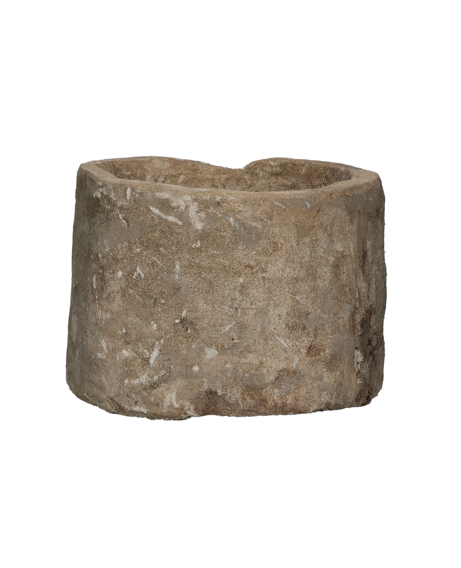 Vintage Indonesian round limestone trough, showing internal and external texture and rough-hewn edges.