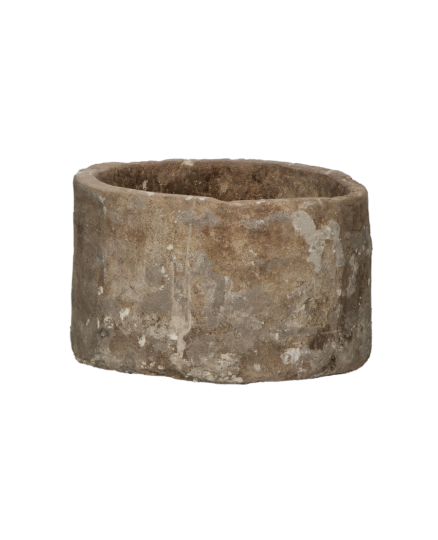 Vintage Indonesian limestone trough, showing textured outer surface and rounded bottom edge.
