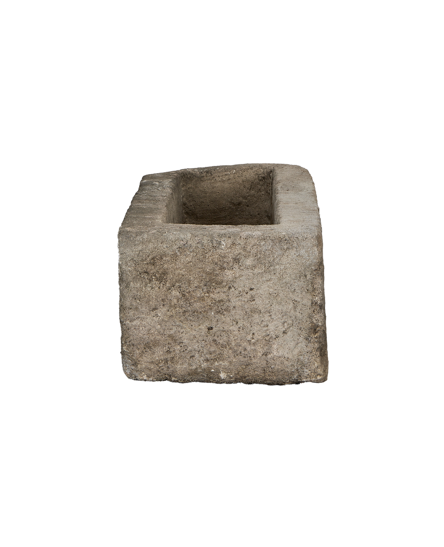 Vintage Indonesian limestone trough closeup, featuring unique rectangular inner surface texture.