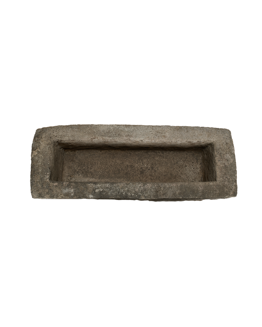 Vintage rectangular limestone trough, top down view revealing weathered, textured rustic interior.
