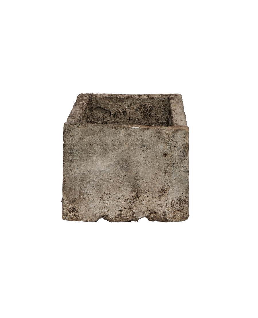 Vintage Indonesian limestone trough viewed from the side, showing rough texture and weathered finish.