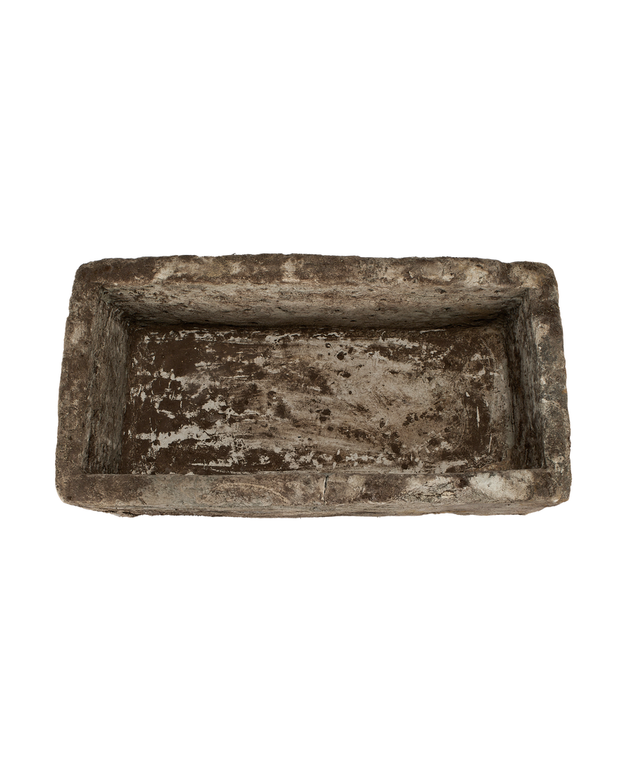 Overhead view of vintage rectangular Indonesian limestone trough with weathered, distressed interior.
