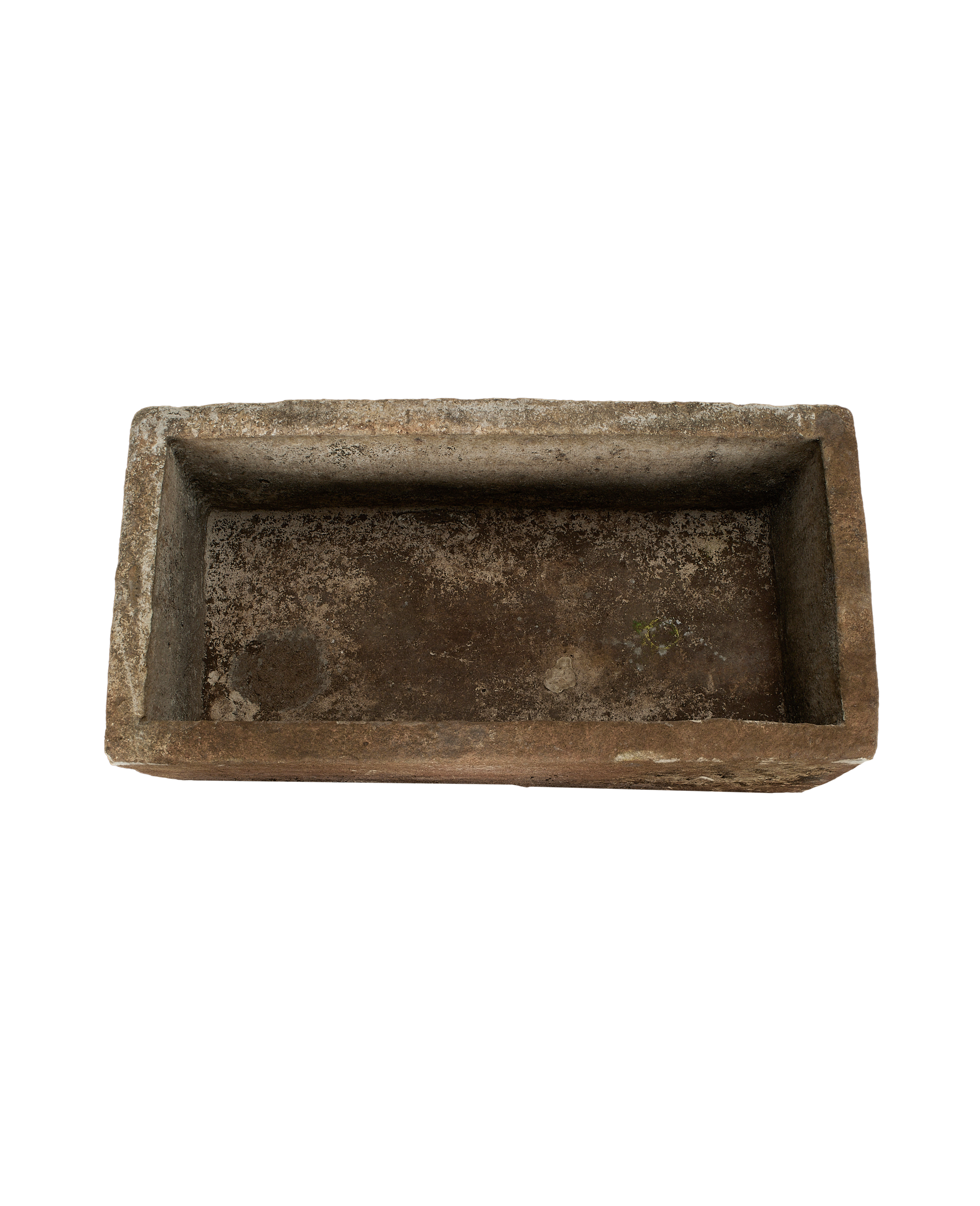 Vintage Indonesian limestone garden trough from a low-angle perspective, showing interior wear and texture.