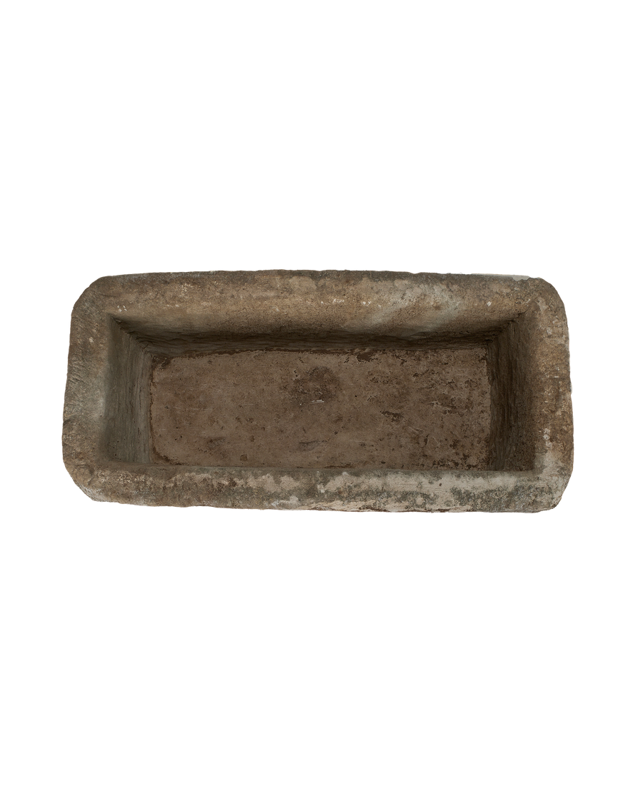 Vintage rectangular limestone trough, overhead view highlighting weathered interior and natural stone texture.