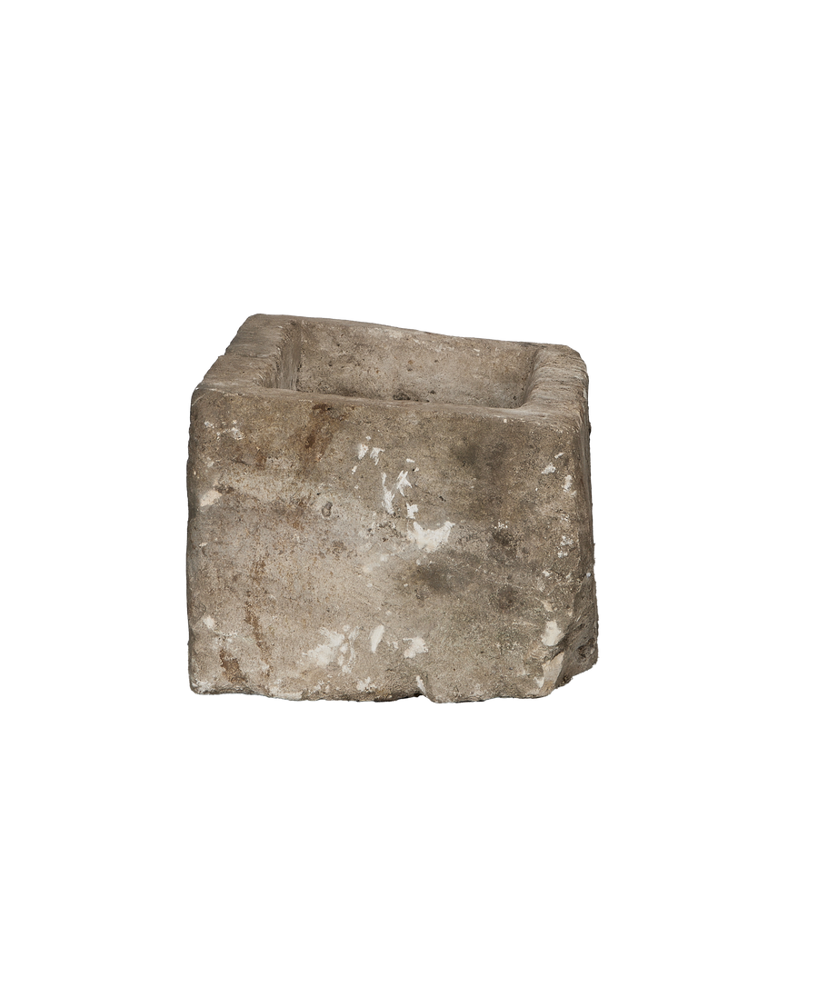 Vintage gray limestone trough with rough, weathered texture showing full interior view.