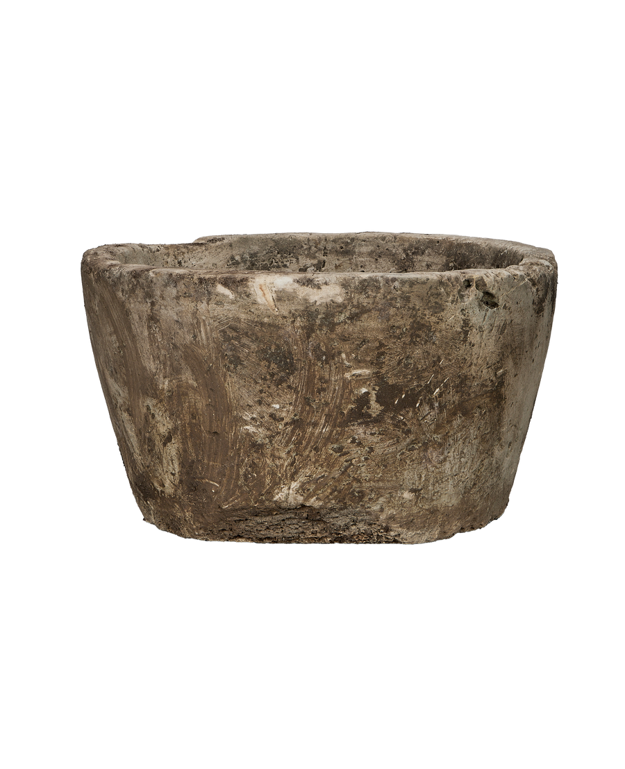 Vintage Indonesian round limestone trough, showcasing textured exterior and distressed surface from a side angle.