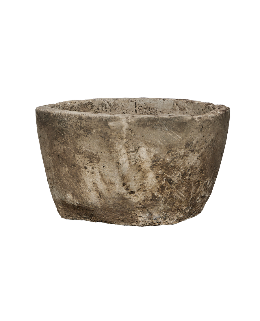 Vintage Indonesian limestone round trough, showing rough exterior texture and chipped rim, 3/4 view.