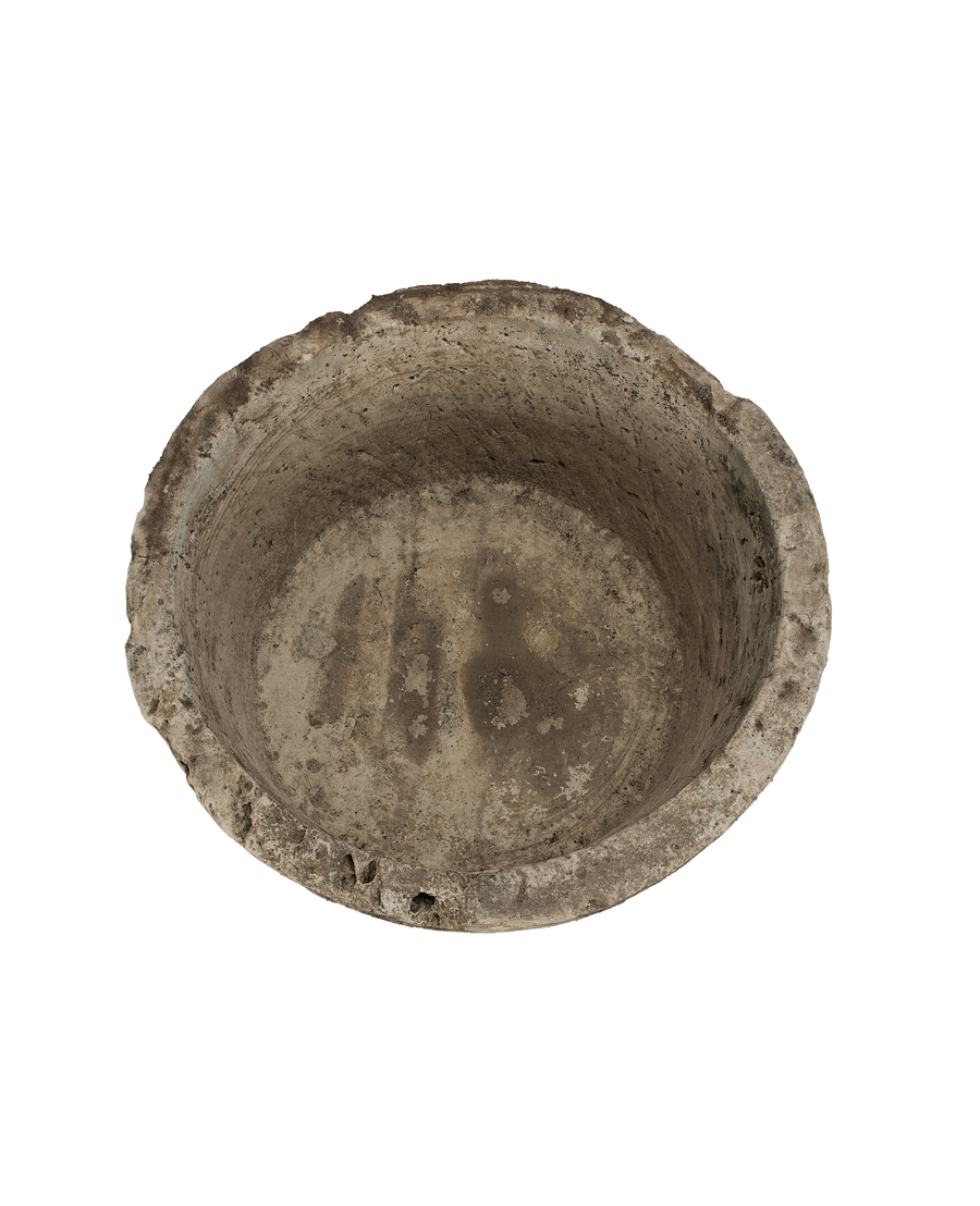 Vintage Indonesian limestone trough, top view of weathered round interior and textured rim.