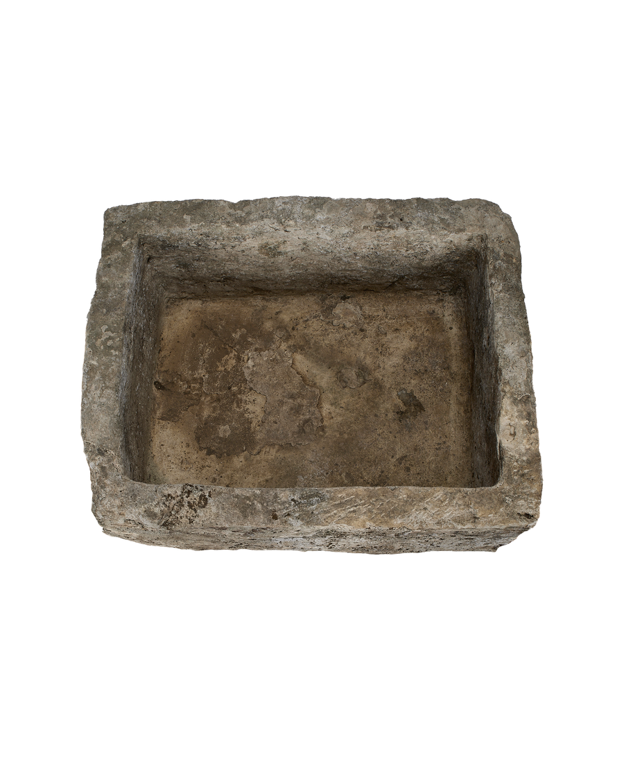 Vintage rectangular limestone trough, top-down view highlighting weathered interior texture, Indonesia.