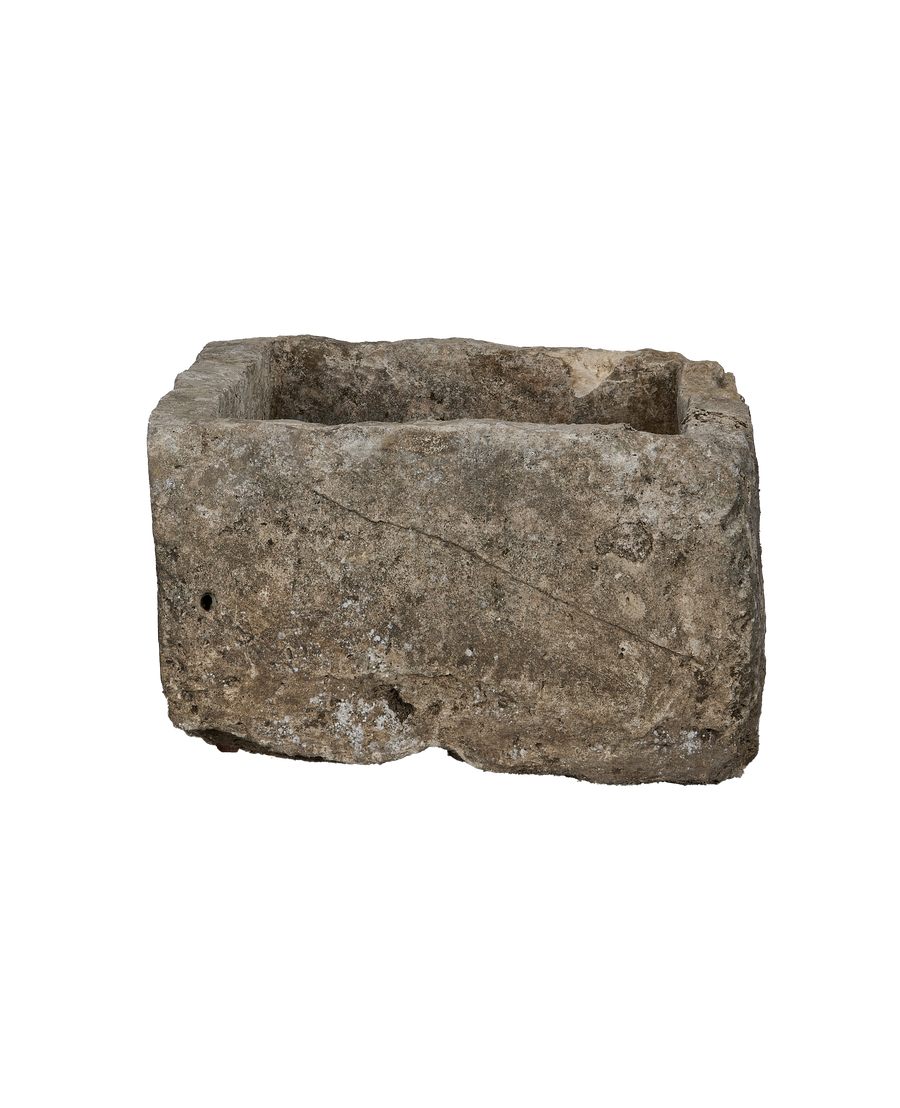 Full view of rectangular vintage Indonesian limestone trough with textured surface and rough edges.