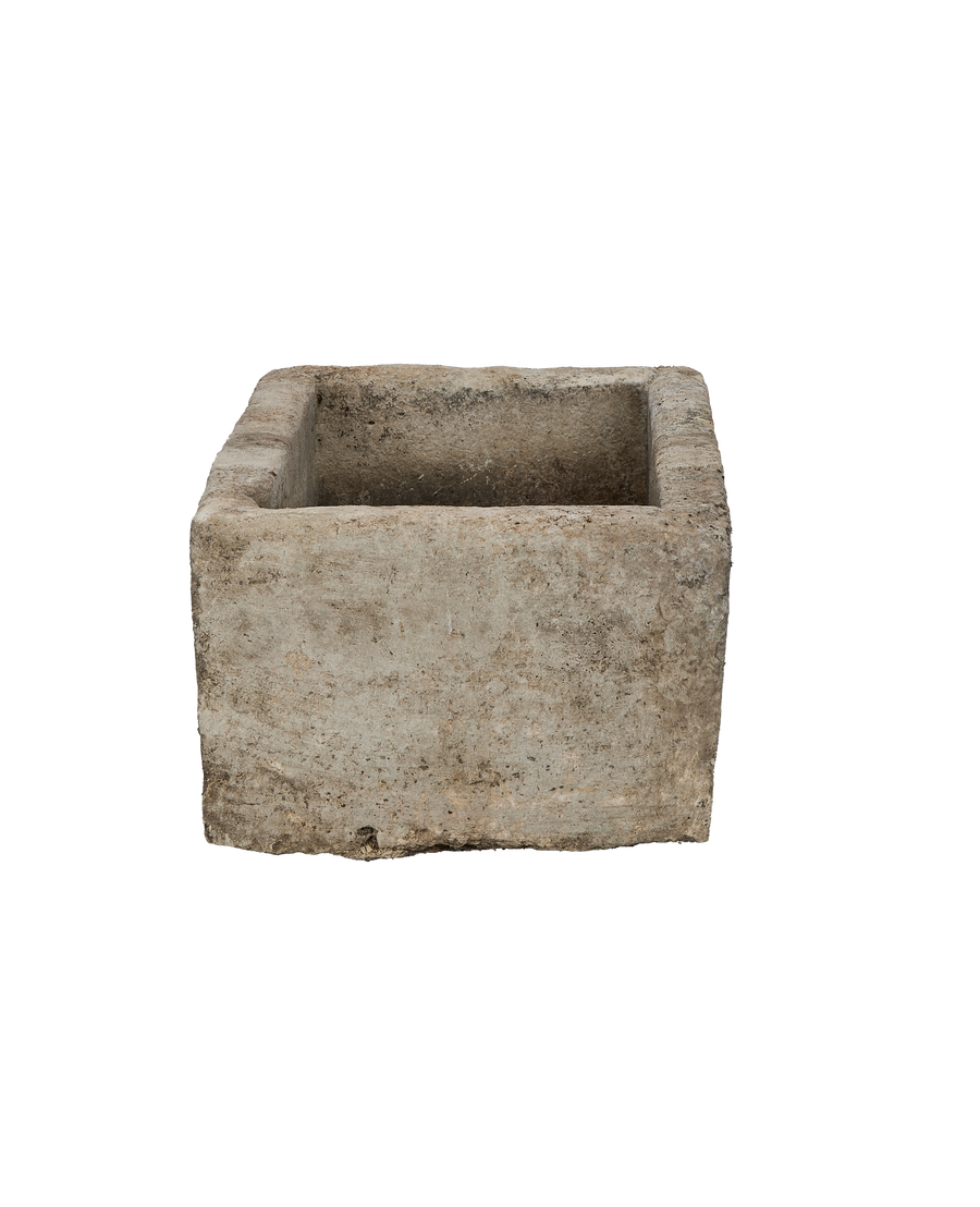 Vintage Indonesian limestone trough viewed from inside, showing distressed surface texture.