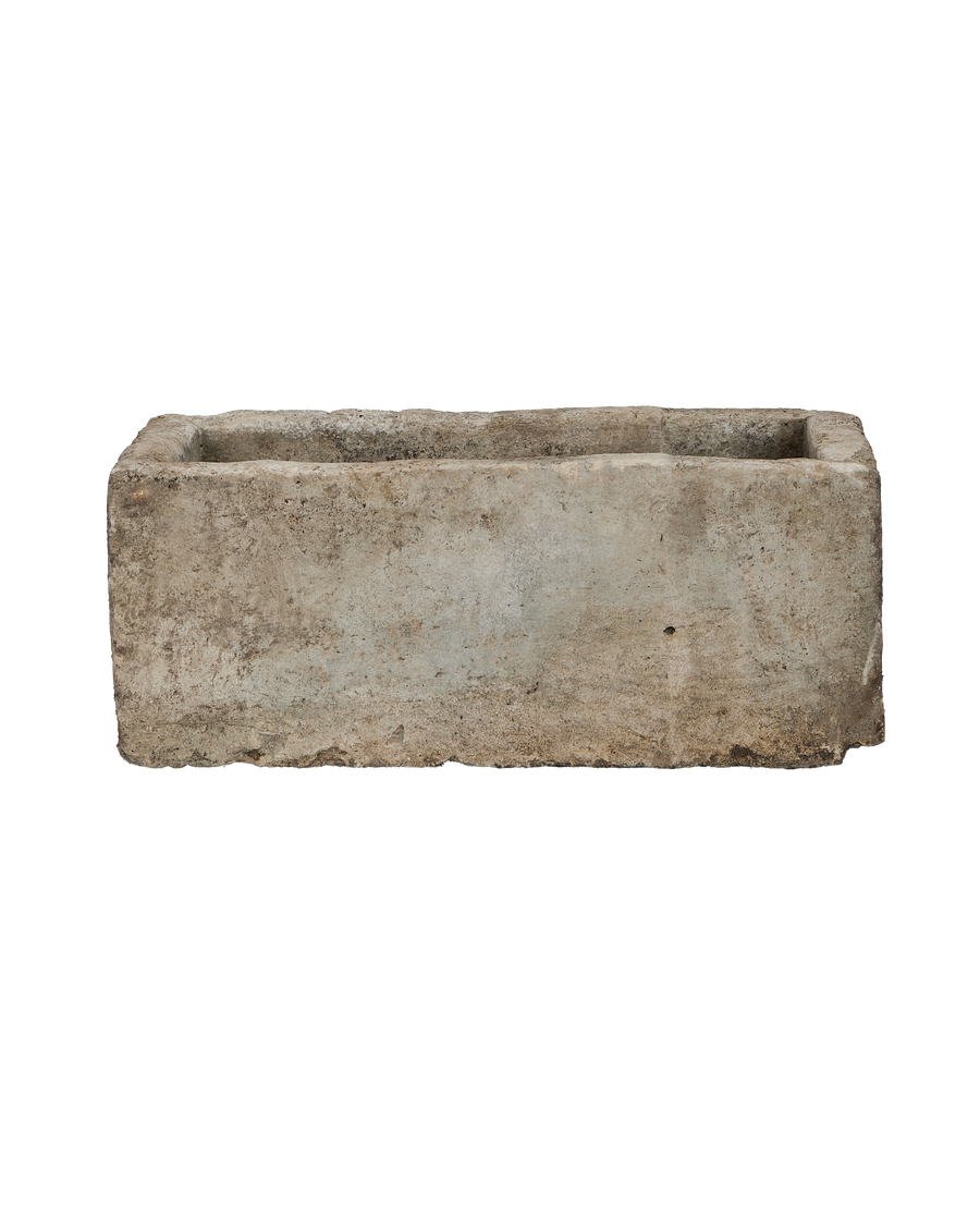 Vintage rectangular Indonesian limestone trough, showing weathered texture on its long side.