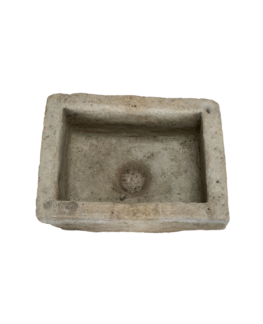 Vintage limestone trough, top-down view highlighting the rectangular form and natural drain hole.