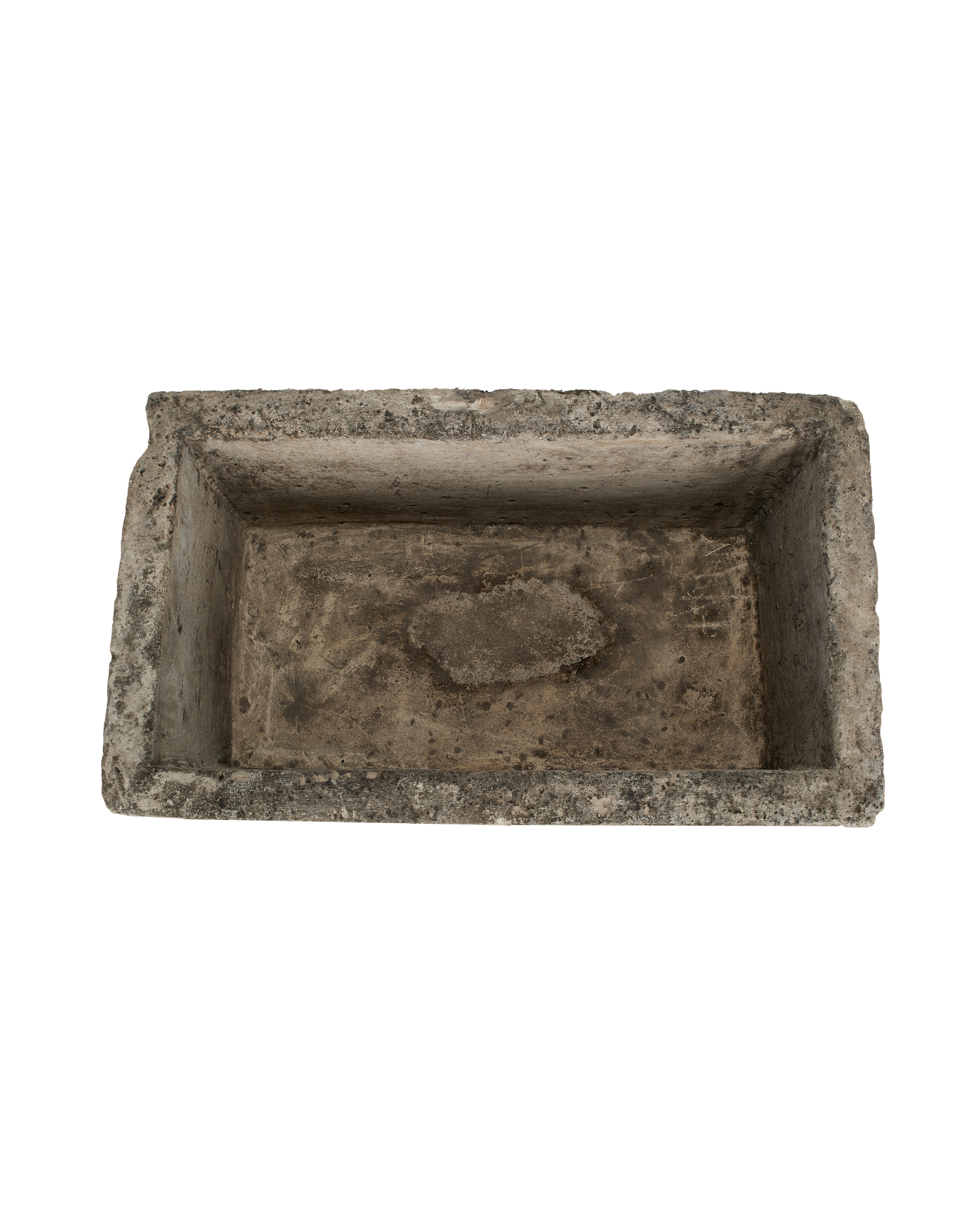 Vintage Indonesian limestone trough closeup, featuring rough-hewn rectangular edges and weathered interior surface.