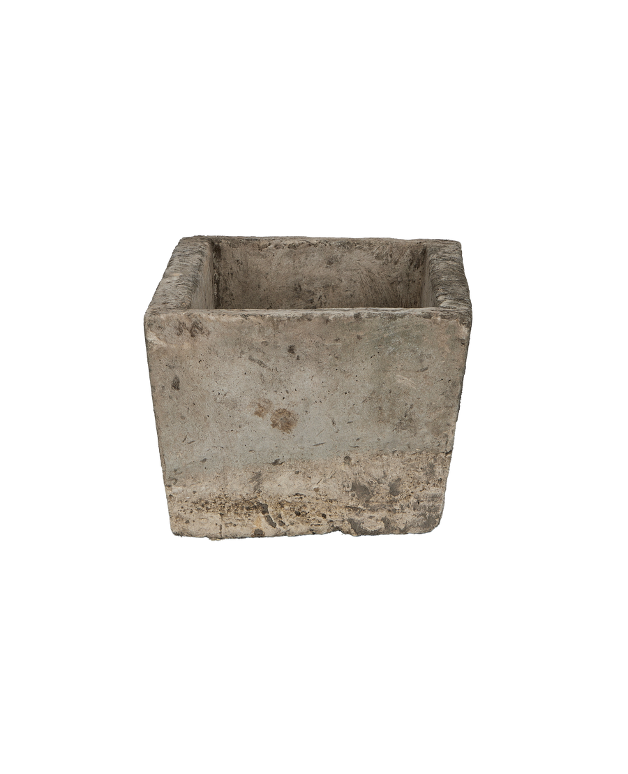 Vintage Indonesian limestone trough viewed from the side, showing rough texture and weathered edges.