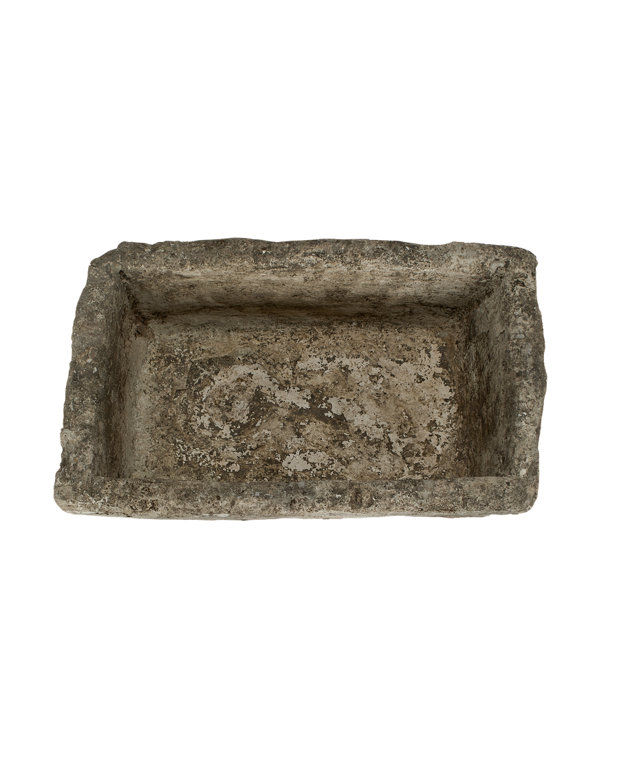 Vintage rectangular limestone trough, top view reveals weathered gray-brown interior, Indonesia.