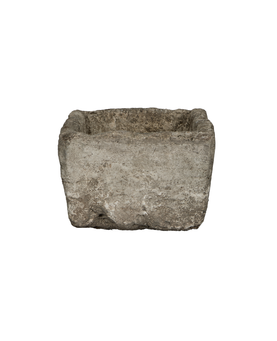 Vintage rectangular Indonesian limestone trough, showing rugged, weathered texture front view.